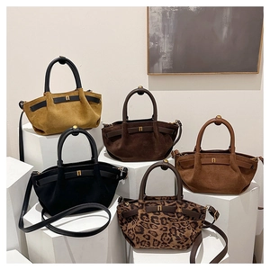 Detailed display of suede handbags in five colors with golden H-shaped metal buckles