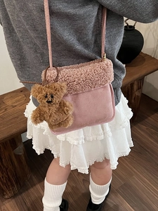 Pink plush crossbody bag for kids with faux suede texture and cute brown bear charm