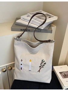 Vintage embroidered cream canvas tote bag with brown leather strap and artistic design