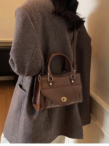 Vintage dark brown PU leather square handbag with golden turn-lock on wool coat
