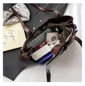 Interior view of brown leather tote showing spacious capacity for cosmetics and perfume