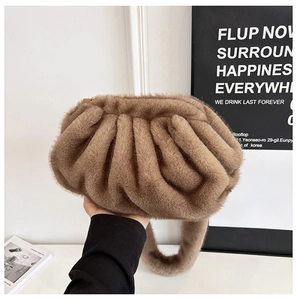 Close-up of brown plush pleated cloud bag with soft faux fur texture and hand-held detail
