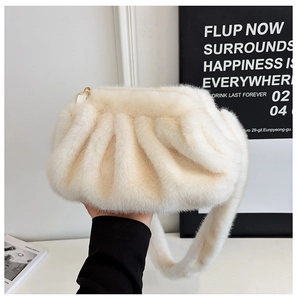Detailed close-up of cream white faux fur cloud bag with soft pleated texture and strap