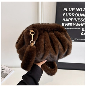 Detail of dark brown faux fur cloud bag with soft pleats and gold metal lobster clasp
