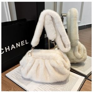 Detail of plush faux fur cloud bag in cream white with gold hardware and fuzzy strap