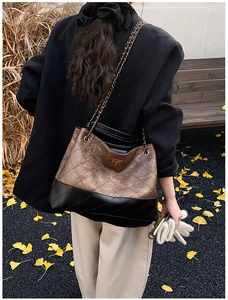 Quilted tote bag with bronze metallic contrast and golden chain strap in autumn setting