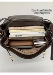 Internal view of the large capacity dark brown tote bag with functional compartments