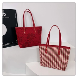 Detail of red floral jacquard and houndstooth tote bags with premium leather handles