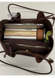 Detail view of large brown tote bag interior with magnetic buckle and high capacity