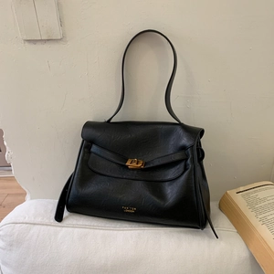 Close-up of black pleated leather shoulder bag with golden buckle and Pan'tor London logo