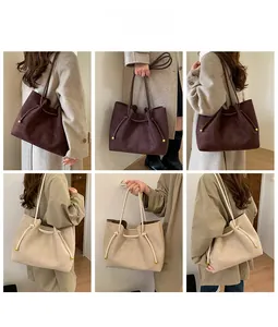 Detail shots of large suede tote bags in chocolate and beige with gold drawstring accents