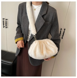 Chic cream faux fur cloud crossbody bag styled with a grey blazer and brown skirt