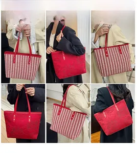 Detail view of red tote bag featuring houndstooth pattern and embossed floral texture