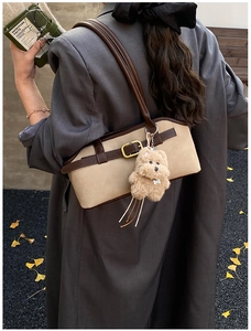 Schicke beige mattierte Baguette-Tasche mit braunem Rand und Teddybär-Anhänger