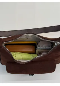 Top view of large brown tote interior showing storage for phone, umbrella, and cosmetics