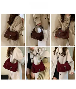 Detail view of retro half-moon suede shoulder bags in dark brown and wine red leather