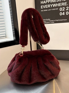 Luxurious burgundy faux fur cloud bag with elegant pleated design and gold hardware