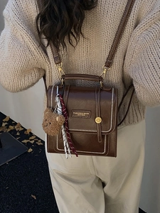 Vintage brown PU leather backpack for women with white stitching and bear charm