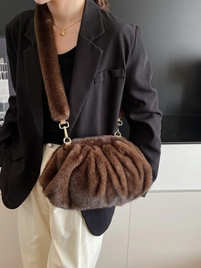 Deep brown faux fur cloud clutch bag with plush texture and golden metal hardware