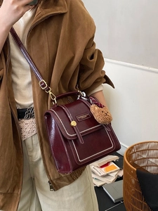 Retro burgundy leather backpack for women with white stitching and bear charm