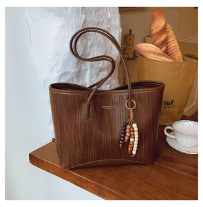 Detail of vintage brown tote bag texture with fashion lettering and boho charm