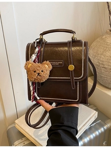 Retro dark brown leather backpack with white beaded trim and cute plush bear charm