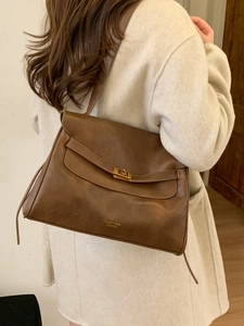 Brown vintage large tote bag with gold metal lock and leather texture for daily commute