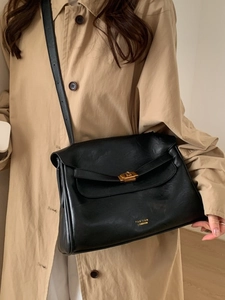 Classic black leather tote bag with gold swivel lock and adjustable shoulder strap