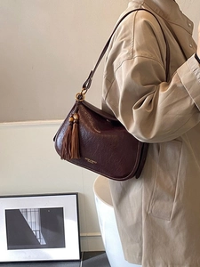 Vintage dark brown matte leather shoulder bag with retro tassels and metal ring detail