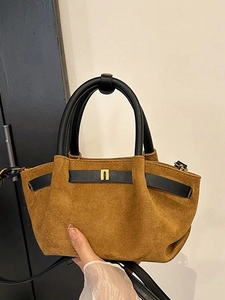 Brown frosted suede handbag with black leather handles and gold metal accents