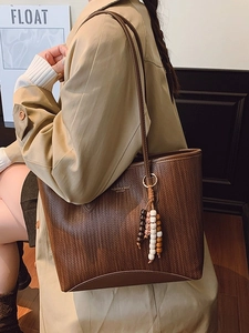 Brown woven tote bag with wooden bead charm for women's autumn winter fashion outfits