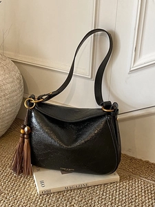 Retro black textured leather hobo bag with brown tassel and gold hardware detail