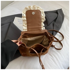 Détail du sac seau en cuir marron avec bordure en dentelle et intérieur à cordon ouvert