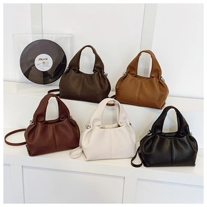 Close-up of pleated litchi grain leather handbags in five classic autumn colors