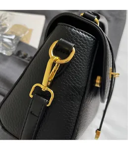 Detail of black lychee leather handbag with premium golden D-ring and metal hook buckle