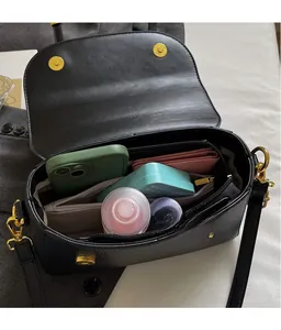 Internal view of the black pebbled leather satchel bag with multiple compartments