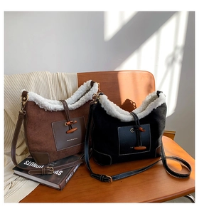 Detail of plush suede shoulder bags with horn button closure in brown and black
