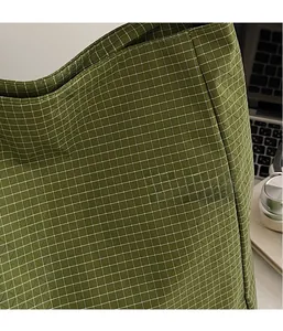 Detailed macro view of the green plaid Oxford fabric on this large capacity tote bag