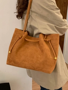 Retro large capacity tan suede tote bag with drawstring for women shown on model