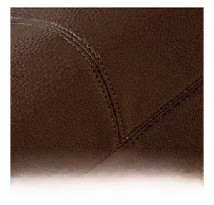 Macro shot showing high-quality double stitching on brown pleated faux leather bag detail
