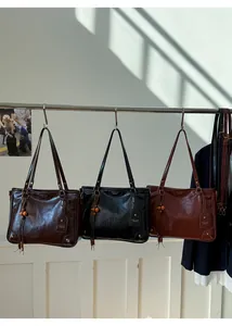 Detailed view of luxury vintage tote bags in coffee, black and brown leather finishes
