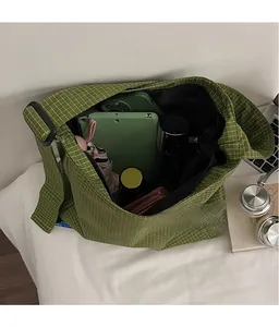 Detail view of large capacity green plaid tote bag showing interior storage space