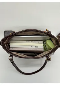 Interior view of large capacity dark brown tote bag with laptop, books and umbrella