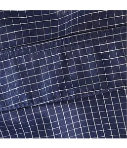 Macro shot of dark blue checkered Oxford fabric showing precise stitching and durable texture