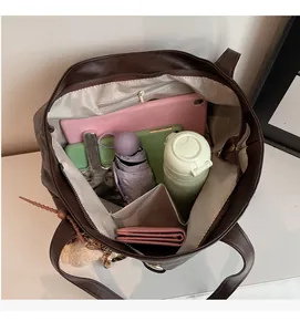 Top view showing large capacity interior of dark brown tote bag with multiple compartments