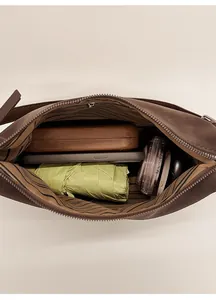 Interior view of vintage leather crossbody bag showing large storage capacity for essentials