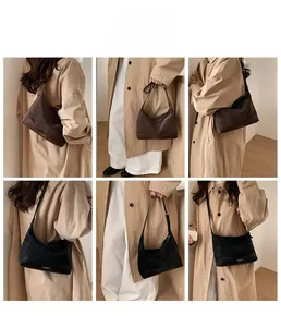 Detailed views of vintage large capacity crossbody bag in brown and black faux suede