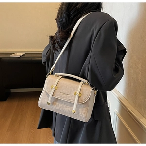 Detail showing the lychee grain texture and gold hardware of the vintage crossbody bag