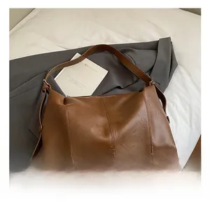 Detail of vintage brown oil wax leather texture on large capacity shoulder tote bag