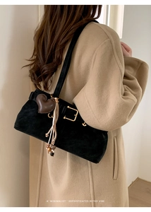 Minimalist black suede shoulder bag featuring a golden square buckle and heart charm detail